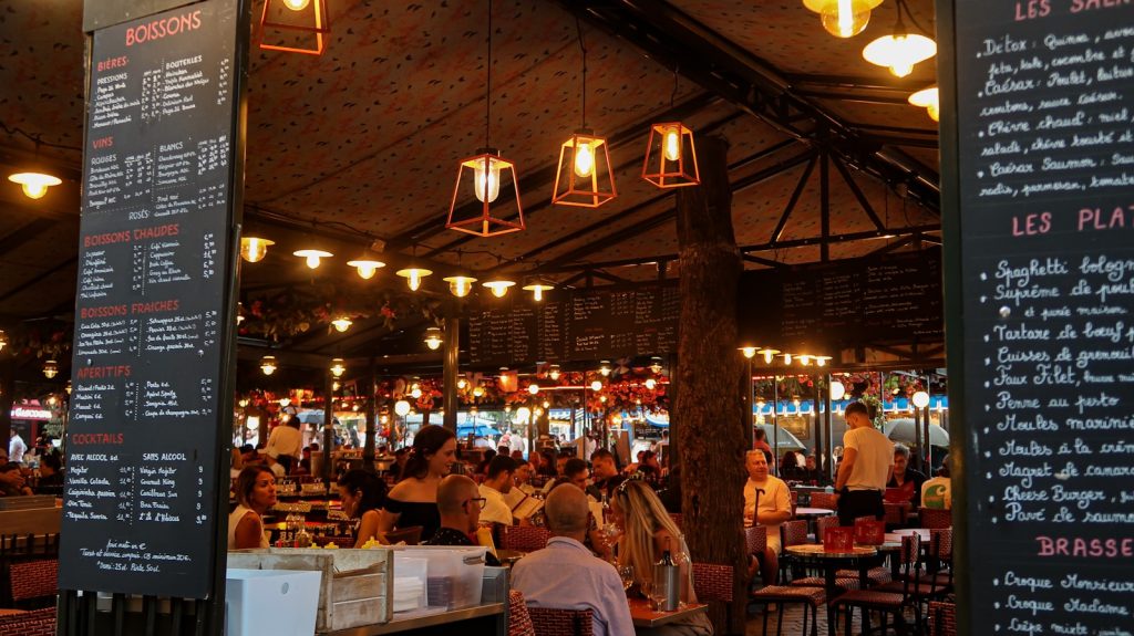 Busy restaurant interior with people dining and menus