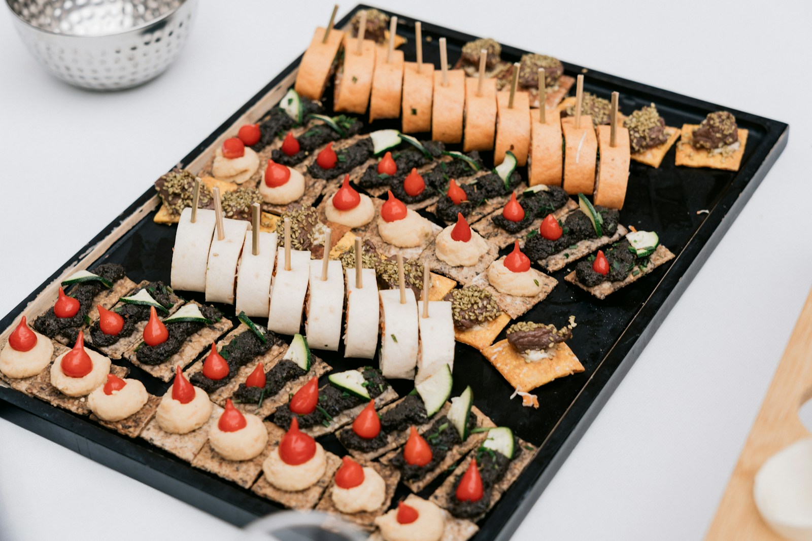Assortment of appetizers on a black tray